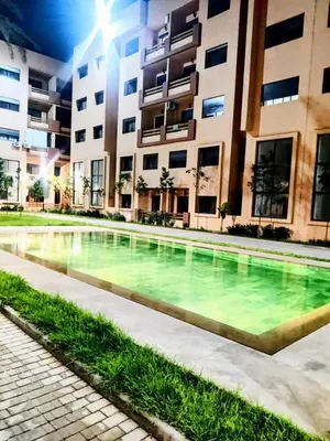 a swimming pool in front of a building at Luxury Stay Nour Prestige Residence, Gueliz in Marrakech