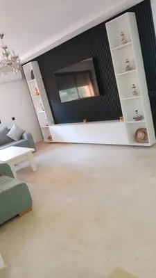 a living room with a couch and a tv at Luxury Stay Nour Prestige Residence, Gueliz in Marrakech