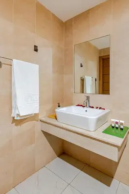 a bathroom with a sink and a mirror at Prestige Hivernage centr de marrakech in Marrakech