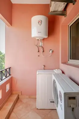 a laundry room with a washing machine and a window at Prestige Hivernage centr de marrakech in Marrakech
