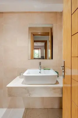 a bathroom with a sink and a mirror at Prestige Hivernage centr de marrakech in Marrakech