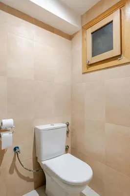 a bathroom with a toilet and a window at Prestige Hivernage centr de marrakech in Marrakech