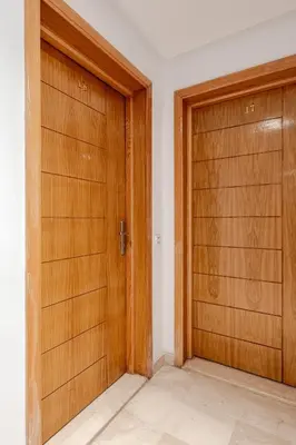 a pair of wooden doors in a room at Prestige Hivernage centr de marrakech in Marrakech