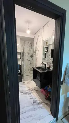 a bathroom with a sink and a mirror at Kamal Atoumi in Marrakech