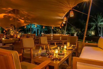 a restaurant with tables and chairs at night at Mandarin Oriental, Marrakech in Marrakech