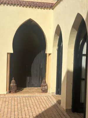 an entry to a building with a black door at Cosy villa a marrakech in Marrakech