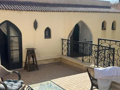 a balcony of a house with a table and chairs at Cosy villa a marrakech in Marrakech