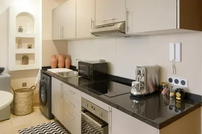 a kitchen with a black counter top and a microwave at Mounir Hamari in Marrakech