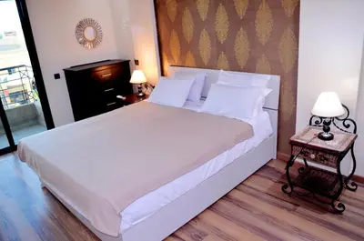 a bedroom with a large bed with white sheets and pillows at Elegant Apartment with Moroccan Charm in Marrakech