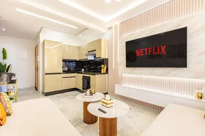 a living room with a television on a wall at Gueliz Chic stay next to Carré Eden in Marrakech