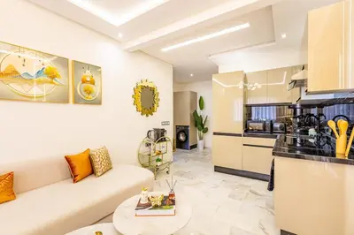 a living room with a couch and a kitchen at Gueliz Chic stay next to Carré Eden in Marrakech