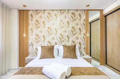 a bedroom with a large white bed and a wall at Gueliz Chic stay next to Carré Eden in Marrakech