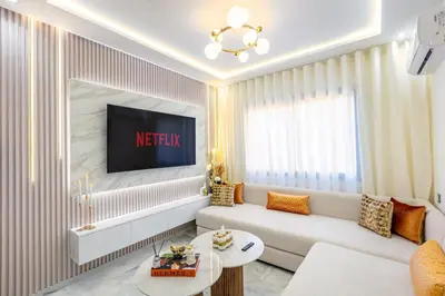 a living room with a couch and a tv at Gueliz Chic stay next to Carré Eden in Marrakech