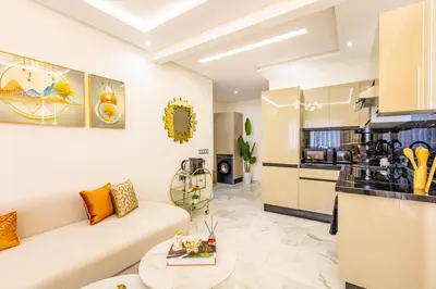 a living room with a couch and a kitchen at Gueliz Chic stay next to Carré Eden in Marrakech