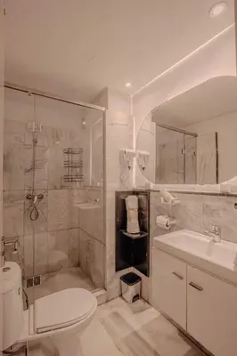 a bathroom with a toilet and a shower and a sink at Modern Flat Gueliz Near Medina Netflix AC in Marrakech