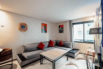 a living room with a couch and a table at Modern Flat Gueliz Near Medina Netflix AC in Marrakech