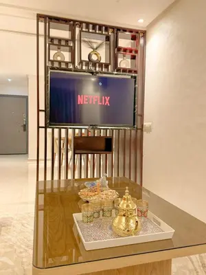 a display case in a store with a television on a wall at La perle de Marrakech in Marrakech
