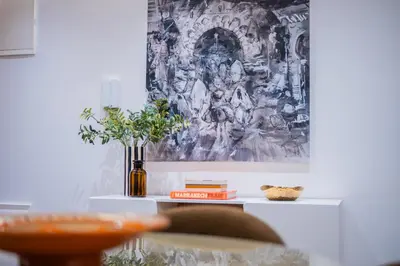 a white table with a painting on the wall at Modern Moroccan Apartment in Gueliz with Terrace in Marrakech