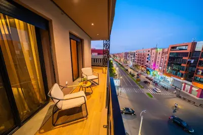a balcony with two chairs and a view of a city at Modern Moroccan Apartment in Gueliz with Terrace in Marrakech