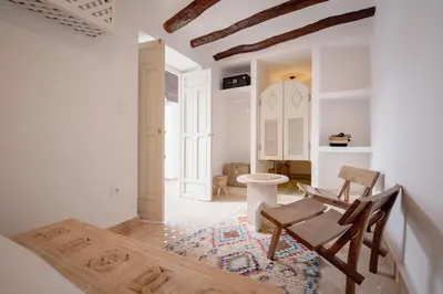 a living room with two chairs and a table at Riad KECH LeS ESSENTIELS in Marrakech