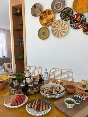 a table with plates and bowls of food on it at Villa Marleanis 5 suites 300m2 piscine chauffée privative 11m de long résidence avec gardien in Marrakech