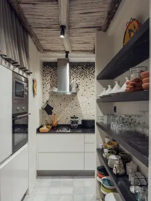 a kitchen with white cabinets and a stove at Maison Etchika in Marrakech