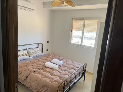 a bedroom with a bed with two towels on it at Appartement 2 chambres meublé Marrakech in Marrakech