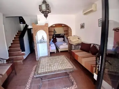 a living room with a couch and a television at La casa de alma in Aït Hamid