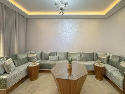a living room with a couch and a table at charming and cozy studio with swimming pool in Marrakech