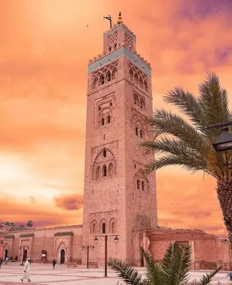 a tall clock tower in front of a building at Nova Gueliz Residence in Marrakech