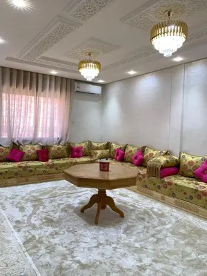 a living room with couches and a coffee table at Omar Hachoum in Marrakech
