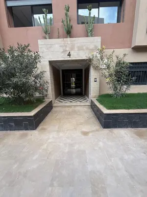 a building with a courtyard with plants in it at Appartement Guéliz 2 piscines, jacuzzi chauffé et fitness in Marrakech
