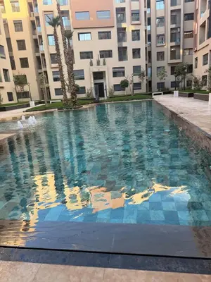 a large swimming pool in front of a building at Appartement Guéliz 2 piscines, jacuzzi chauffé et fitness in Marrakech