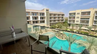a balcony with a view of a swimming pool at Luxury Pastel Suite with Balcony & Pool in Marrakech