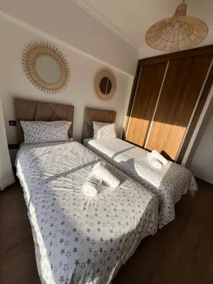 a bedroom with two beds with towels on them at Appart 2 chambres Gueliz in Marrakech