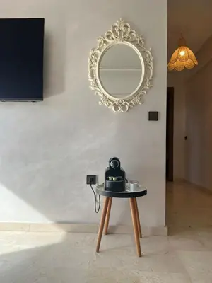 a mirror and a table with a tea kettle on it at Appart 2 chambres Gueliz in Marrakech