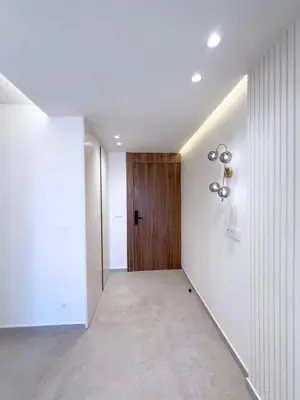 an empty hallway with a wooden door in a building at Modern & luxurious apartment in Victor Hugo, Marrakech in Marrakech