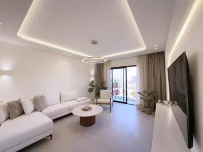 a living room with a white couch and a table at Modern & luxurious apartment in Victor Hugo, Marrakech in Marrakech