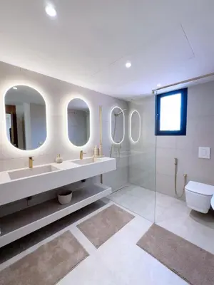 a bathroom with two sinks and a toilet and mirrors at Modern & luxurious apartment in Victor Hugo, Marrakech in Marrakech
