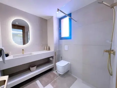 a bathroom with a sink and a toilet and a mirror at Modern & luxurious apartment in Victor Hugo, Marrakech in Marrakech
