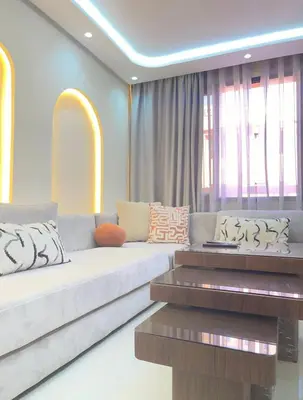 a living room with a couch and a table at Welcome to your peaceful getaway in Marrakech! in Marrakech
