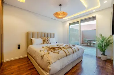 a bedroom with a large bed and a large window at Le Nahla - Centre - 4 Prs - Terrasse in Marrakech