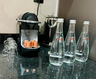 a group of bottles of water on a counter at Calme & Confort Mabroka - 2 chambre in Marrakech