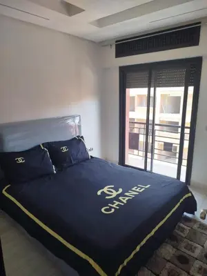 a bed in a room with a large window at kech vacations 2 bedroom luxury gulize apartment in Marrakech