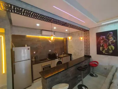 a kitchen with a refrigerator and a counter top at kech vacations 2 bedroom luxury gulize apartment in Marrakech