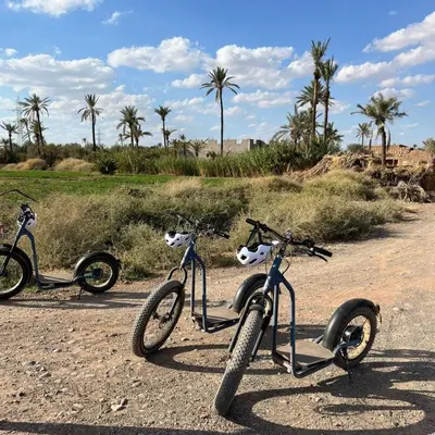 two bikes parked on a dirt road with palm trees at Studio With Pool Marrakesh in Marrakech