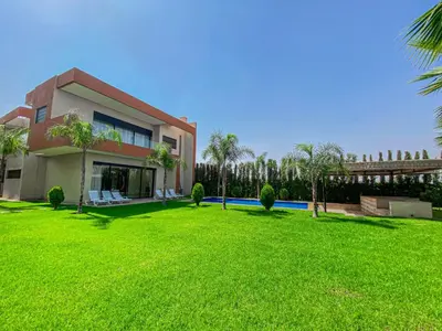 a house with a large lawn in front of it at Argan golf in Marrakech