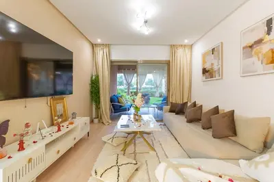 a living room with a couch and a table at Luxury apartment in Prestigia Opale in Marrakech