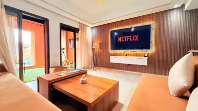 a living room with a television on a wall at Chic Stay in Gueliz 1 in Marrakech