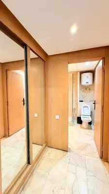 a bathroom with a toilet and sliding glass doors at Chic Stay in Gueliz 1 in Marrakech